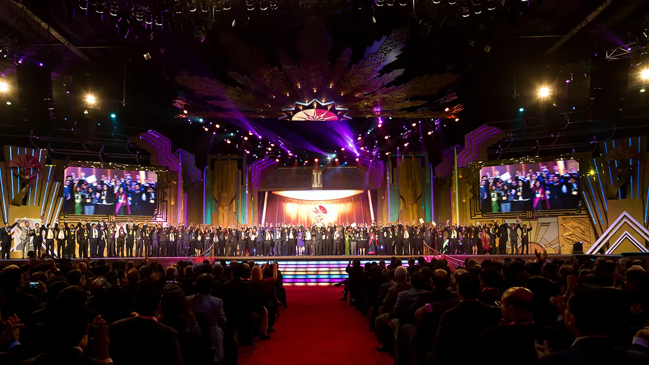 All award winners on stage beneath a monumental art deco set, showcasing large-scale creative direction and brand-aligned spectacle for Aditya Birla Group Awards