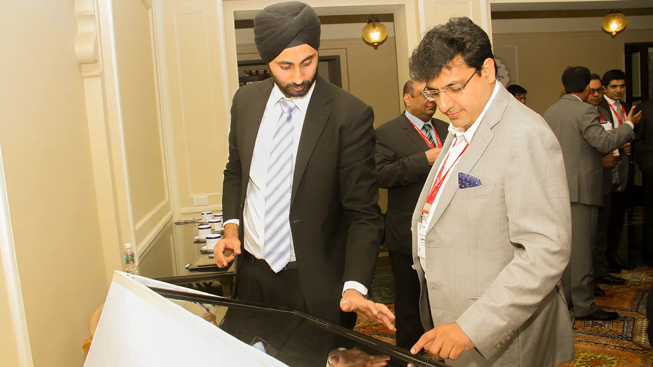 Guests exploring Audi features on touchscreen display during conference, showcasing digital interactivity and audience engagement strategy