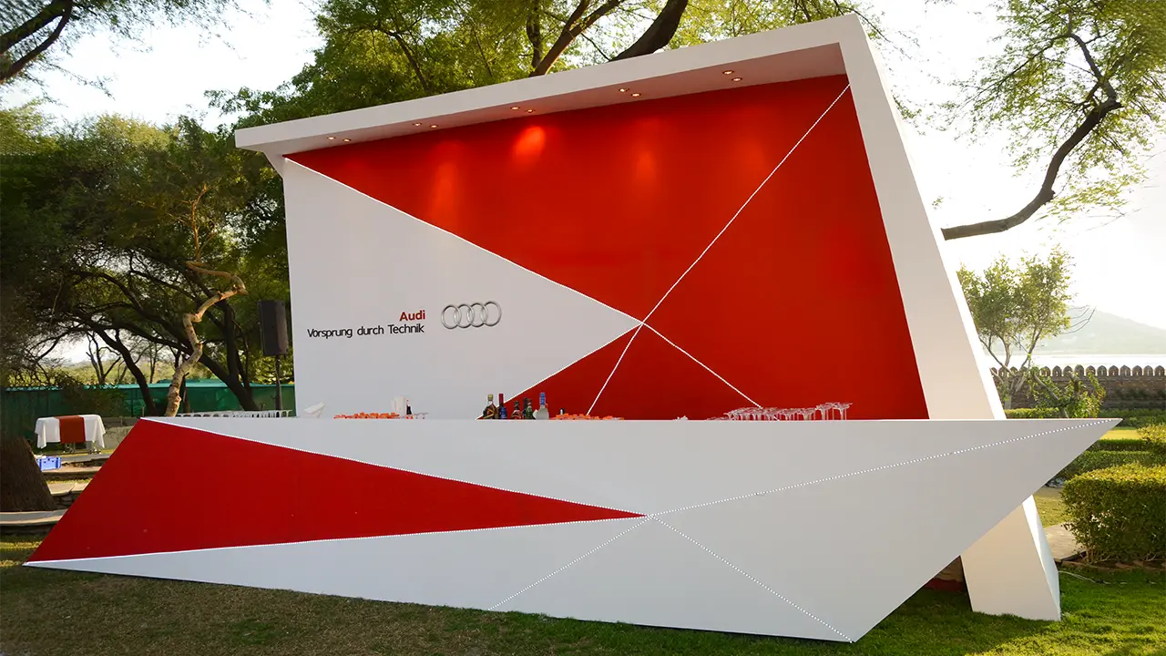 Audi-branded geometric outdoor bar installation blending luxury hospitality design with premium brand aesthetics and guest experience