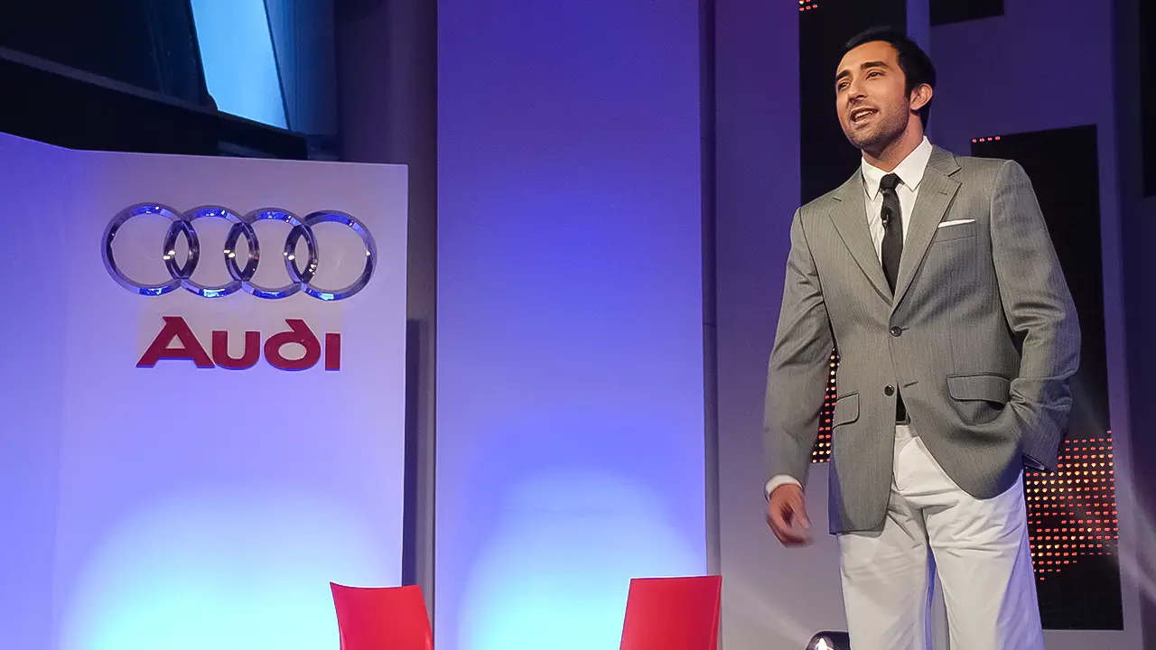 Host presenting at Audi Q5 India launch, showcasing brand-aligned stage design and premium automotive event scripting