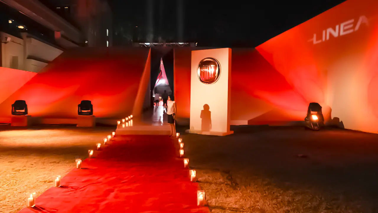 Candlelit red carpet entry at Fiat Linea India launch event showcasing experiential design and brand-led spatial storytelling