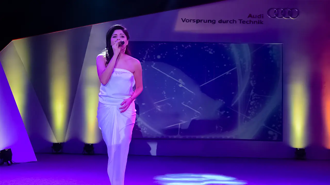 Live musical performance with branded stage design at Audi Partner Awards showcasing experiential event production skills