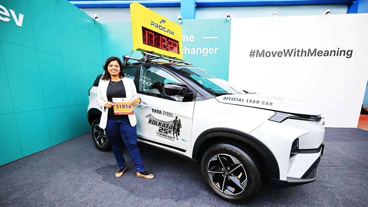 Official Lead Car at Tata Steel Kolkata 25K with Procam digital timer and event branding, showcased against a branded Tata.ev backdrop