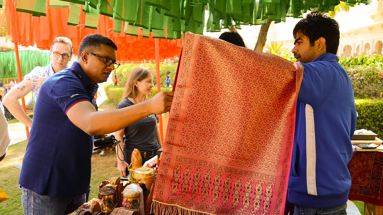 Guests exploring artisanal textiles at Audi's Royal Flea Market brunch showcasing cultural curation and experiential brand design